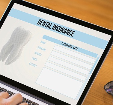 Patient filling out dental insurance form on computer